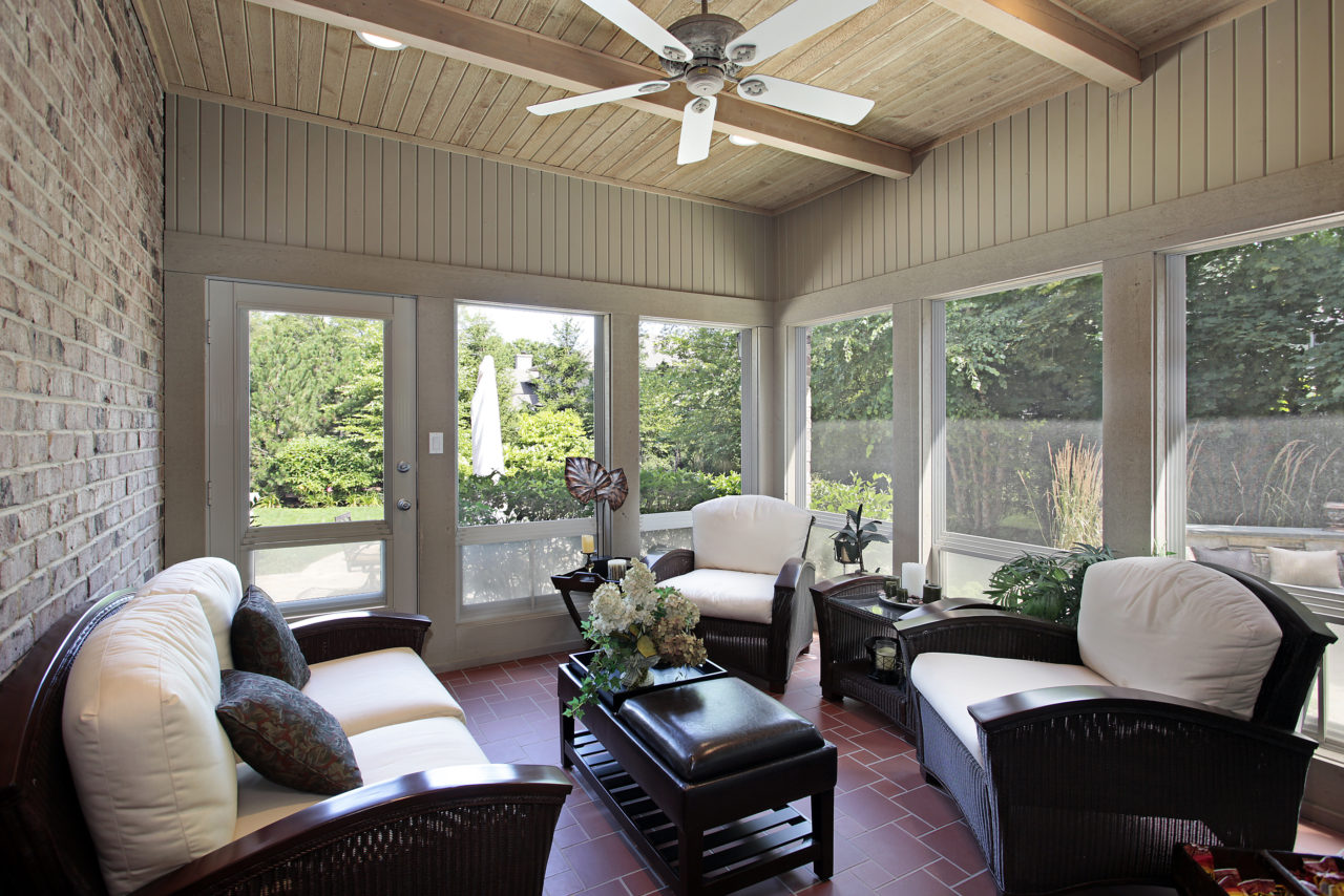 Sunlit Florida room with vinyl windows overlooking a Florida backyard